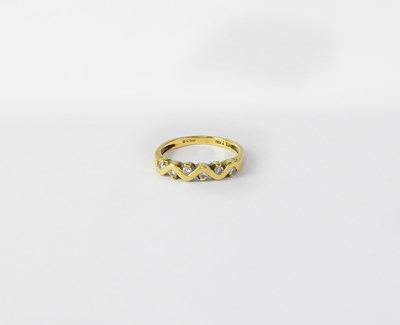 Lot 1092 - An 18ct yellow gold ring with six small collet...