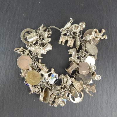 Lot 1188 - A hallmarked silver charm bracelet with a...