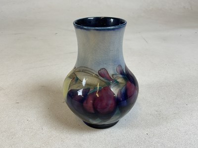 Lot 260 - MOORCROFT; a blue 'Wisteria' vase, green...