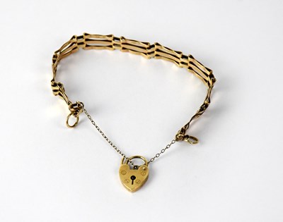 Lot 1165 - A 9ct gold three bar gate bracelet with...