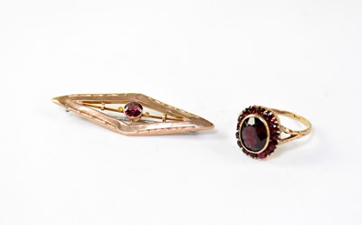Lot 1044 - A 9ct gold ring set with garnets in a cluster...