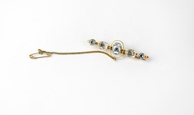 Lot 1199 - A 9ct gold bar brooch set with five topaz...