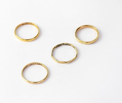 Lot 990 - Four wedding rings comprising a 22ct example,...