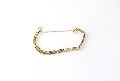 Lot 1166 - A 9ct gold three bar gate bracelet with safety...