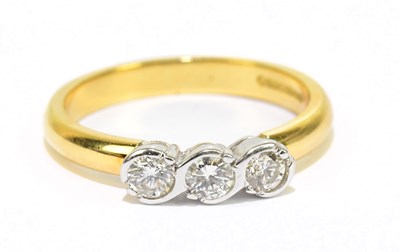 Lot 905D - An 18ct yellow gold dress ring, set with three...