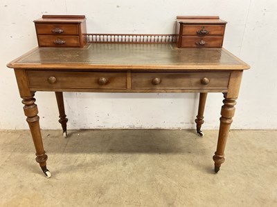 Lot 501 - A leather topped writing desk with two main...