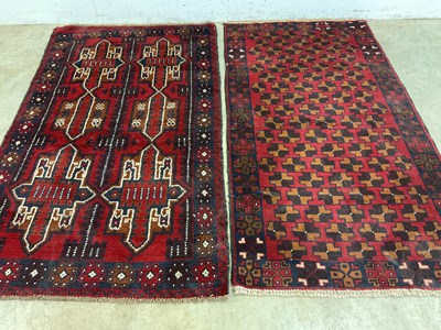 Lot 457 - An Afghan small red and blue bedroom rug and a...