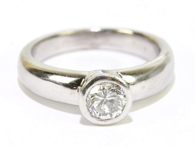 Lot 905C - An 18ct white gold diamond solitaire rub-over...