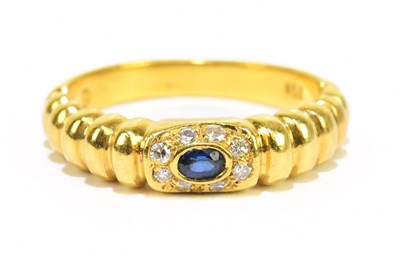 Lot 905I - A modern 18ct yellow gold diamond and sapphire...