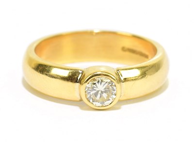 Lot 905K - An 18ct yellow gold diamond set solitaire ring,...