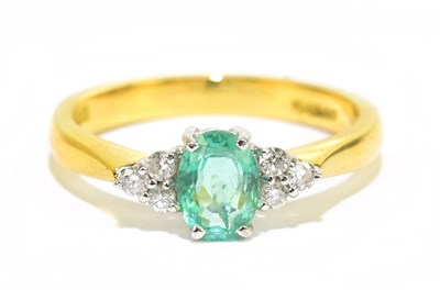 Lot 905R - An 18ct yellow gold emerald and diamond dress...