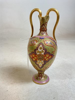 Lot 253 - A Persian style gilded vase with twin handles,...