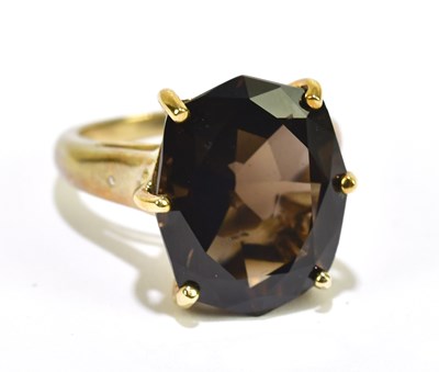 Lot 1046 - A 9ct yellow gold dress ring set with a single...