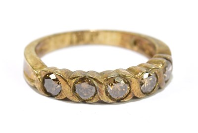 Lot 1111 - A yellow metal five stone dress ring, stamped...