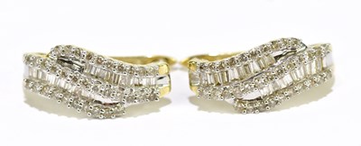 Lot 1279 - A pair of yellow metal earrings set with...