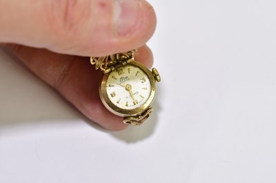 Lot 1034 - A 9ct yellow gold watch ring, the dial set...