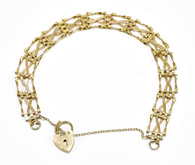 Lot 1158 - A 9ct yellow gold gate bracelet with padlock...