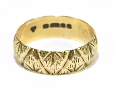 Lot 1109 - A 9ct yellow gold textured wedding band, size...