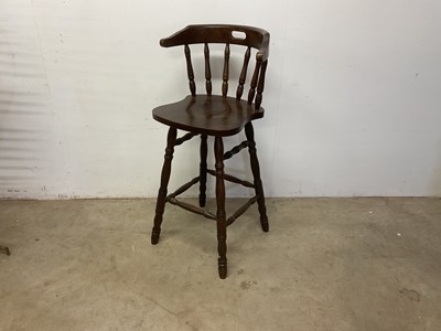 Lot 610 - A stained wood high stool with back support,...