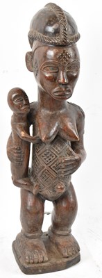 Lot 37 - A Baule, Ivory Coast, figure holding a child...