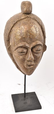 Lot 66 - A Baule, Ivory Coast, brass clad mask...