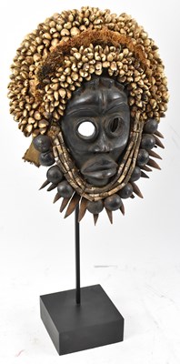 Lot 69 - A Dan, Ivory Coast, mask adorned with cowry...