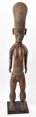 Lot 93 - A Yoruba, Nigeria, standing figure raised on...