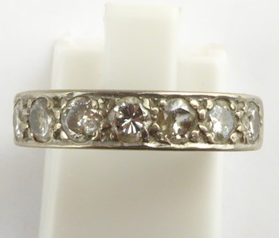 Lot 895 - An 18ct white gold half eternity ring set with...