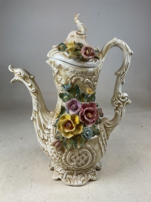 Lot 246 - CAPODIMONTE; a large floral encrusted ewer,...