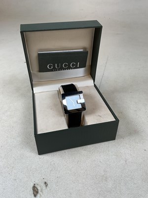 Lot 375 - GUCCI; a stainless steel black faced...