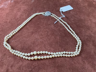 Lot 307 - A two strand graduated cultured pearl necklace,...