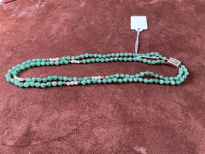 Lot 308 - A two row hand tied jade bead, gold and pearl...