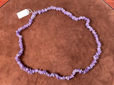 Lot 345 - A rough cut amethyst necklace, length 80cm.