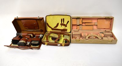 Lot 155 - Three vanity sets, a brown leather case...