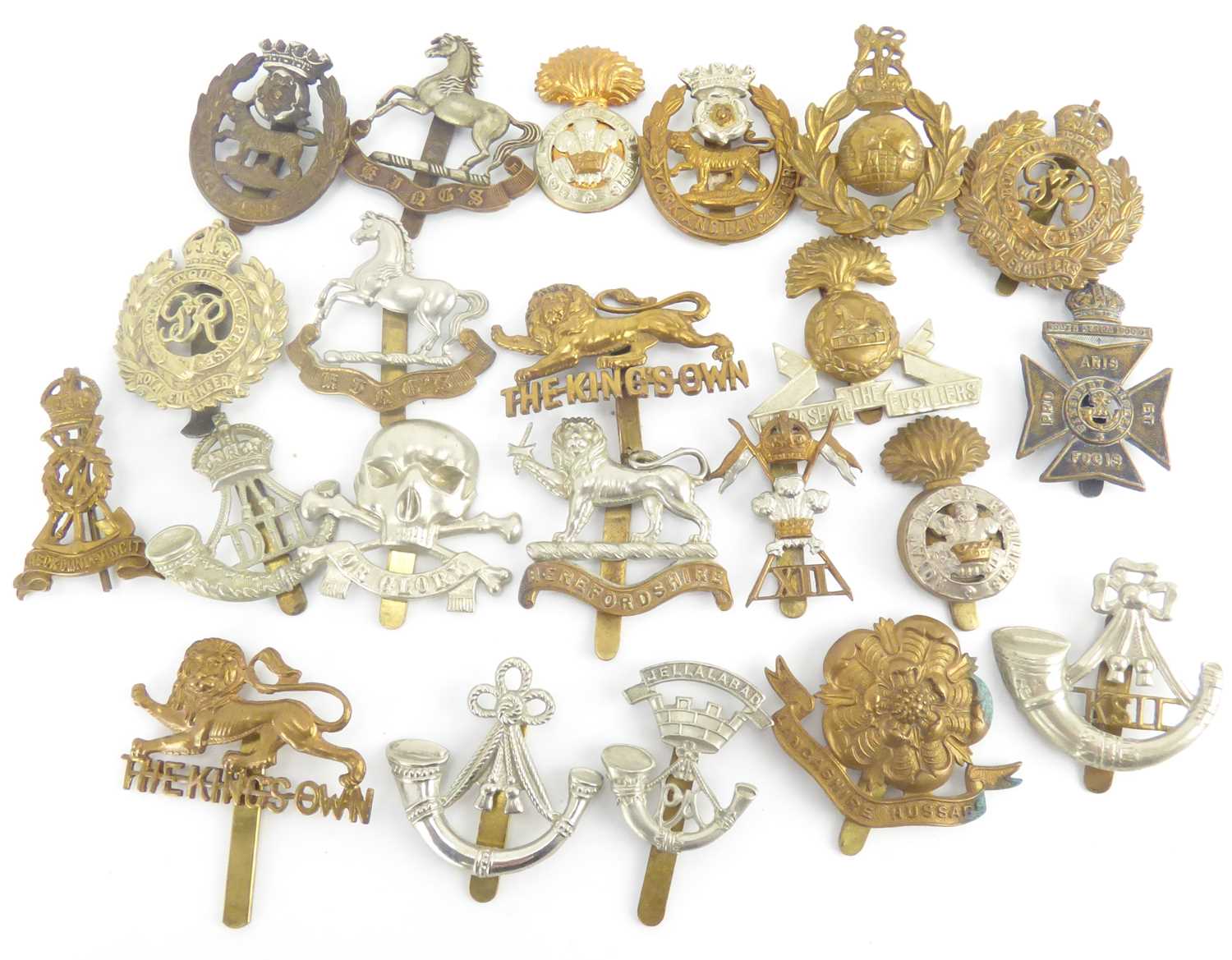 Lot 380 - Twenty-two cap badges to include