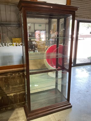 Lot 485 - Howard Miller; a tall modern display cabinet...