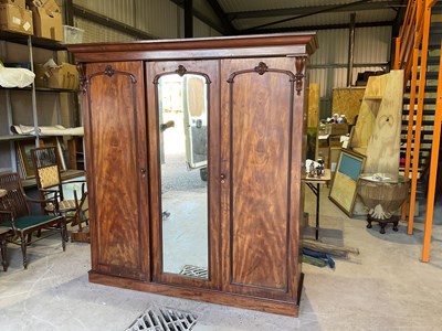 Lot 479 - A mahogany triple wardrobe with one mirrored...