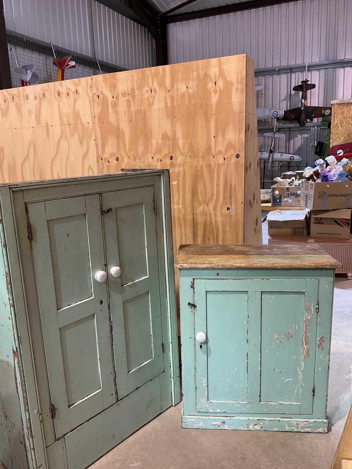 Lot 491 - Two green painted pine kitchen cupboards,...