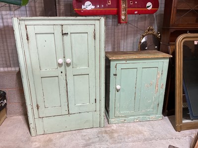 Lot 491 - Two green painted pine kitchen cupboards,...