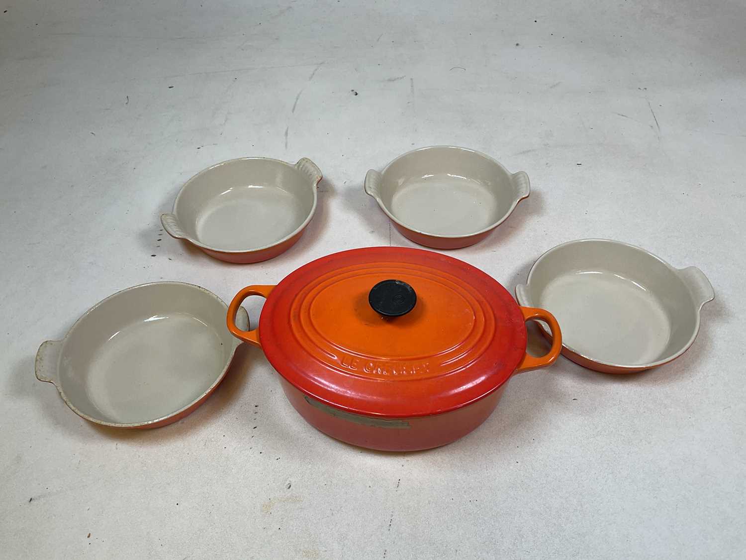 Lot 101 - A Le Creuset oval casserole dish, width 26cm,...