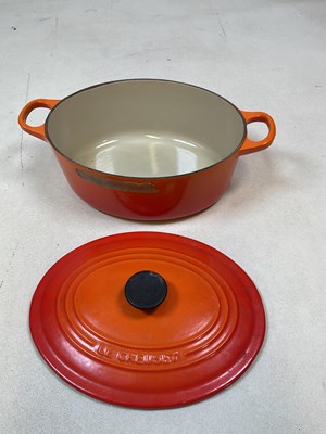 Lot 101 - A Le Creuset oval casserole dish, width 26cm,...