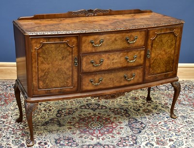Lot 2571 - A 1950's burr walnut veneered sideboard, with...