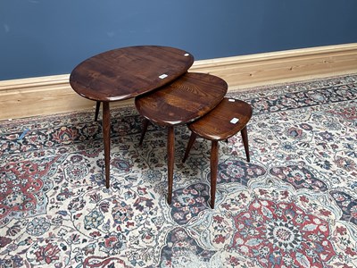Lot 2540 - ERCOL; a nest of dark elm pebble coffee tables,...