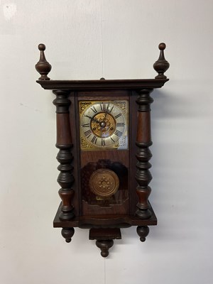 Lot 405 - A hanging wall clock with brass face and glass...