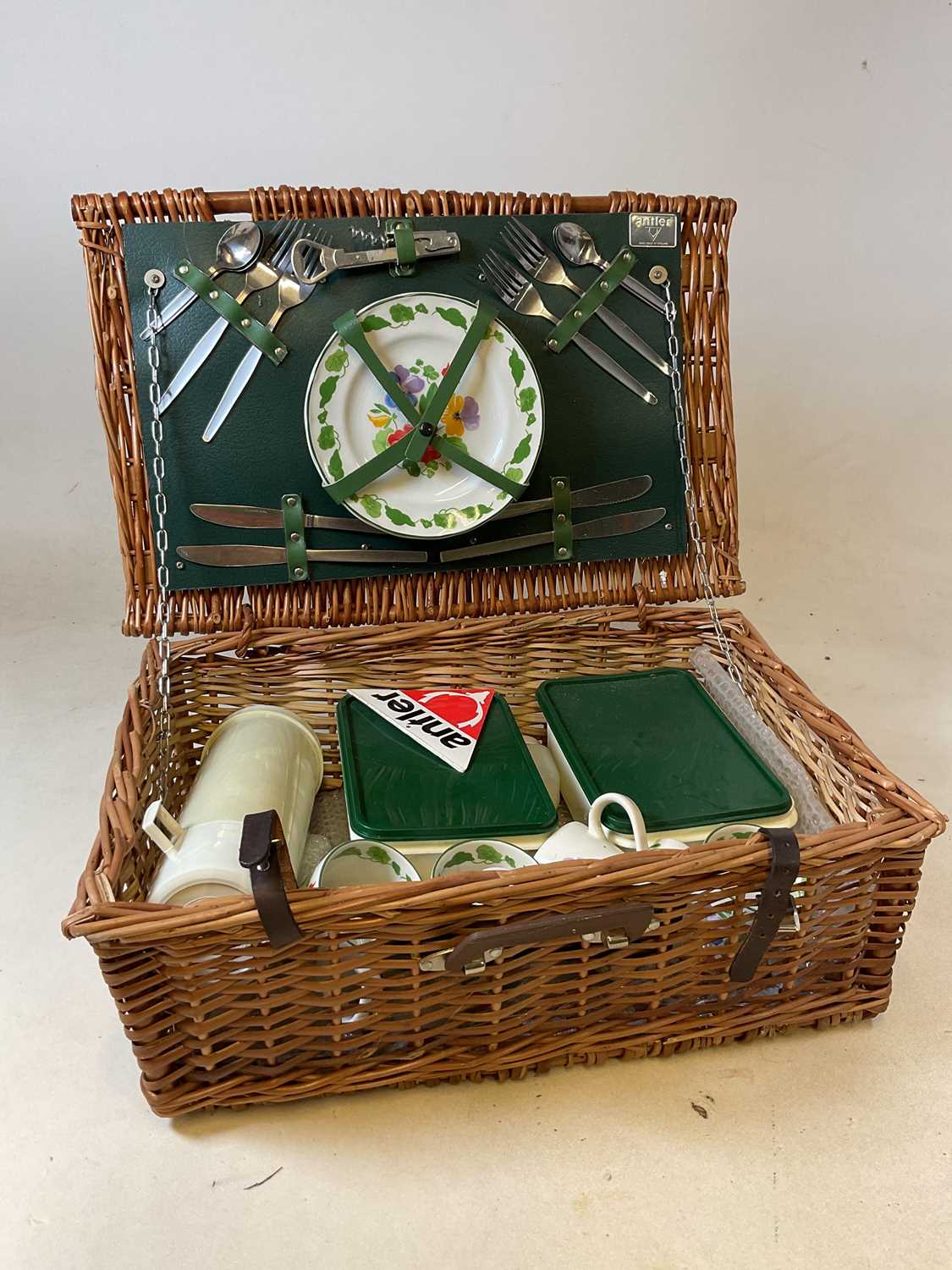 Lot 100 - A wicker picnic hamper, four settings, by Antler.