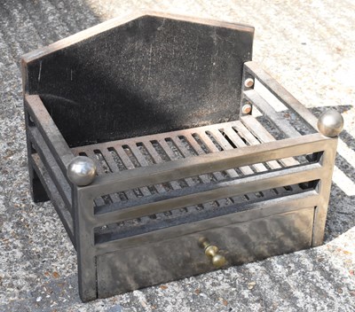 Lot 392 - A cast iron and brass fire grate, width 40cm.