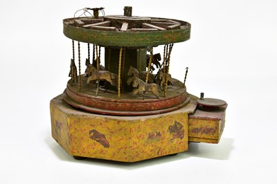 Lot 260 - A circa 1900s winding carousel, height 24cm.