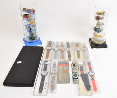 Lot 678 - SWATCH; two perspex towers containing twelve...
