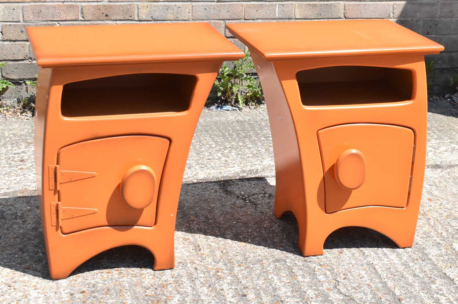 Lot 65 - A pair of modern orange bedside tables, width...