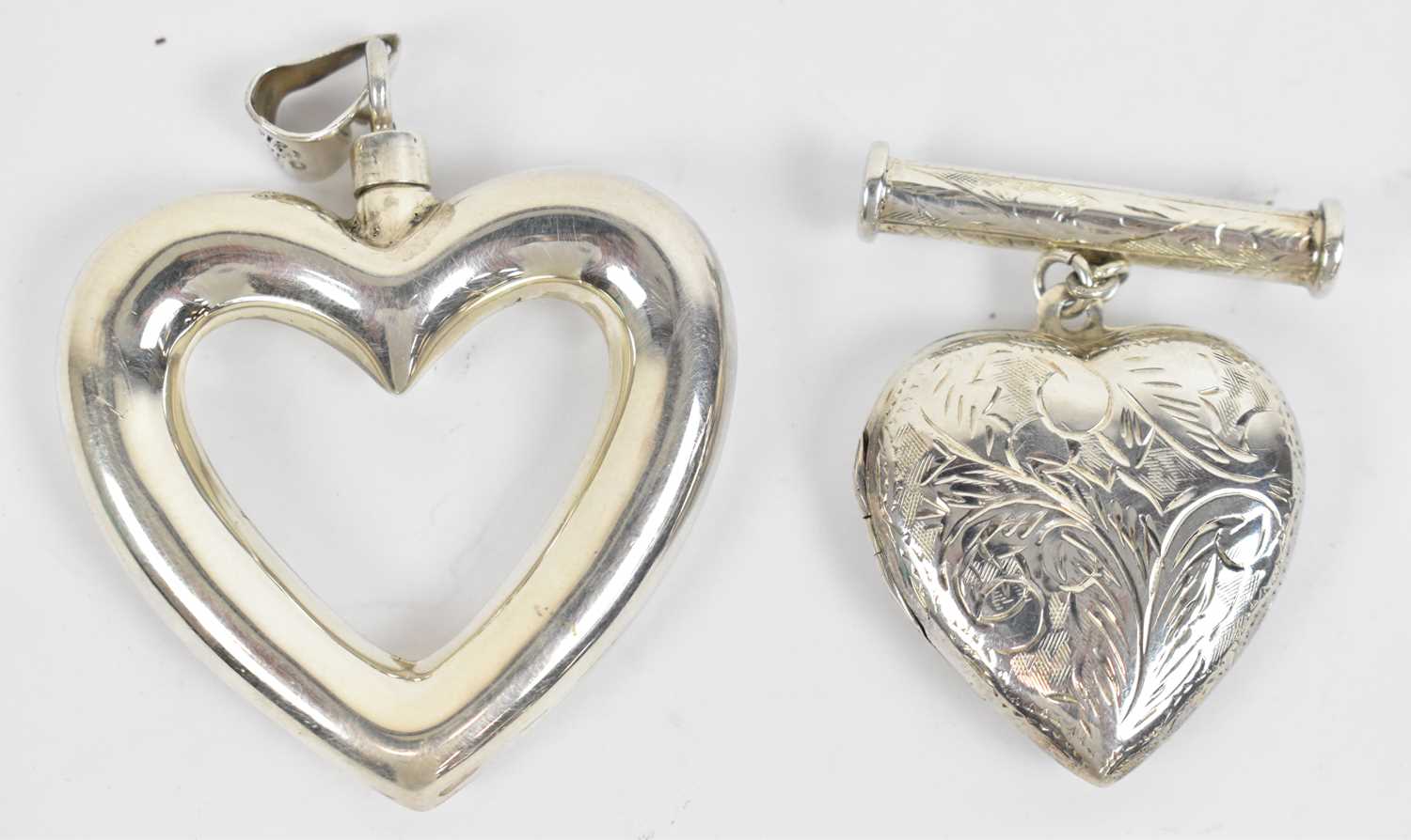 Lot 643 - A hallmarked silver love heart shaped pendant...